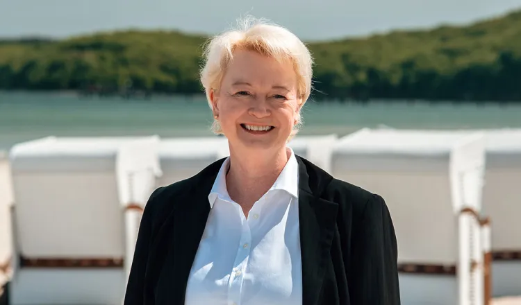 Lächelnde Empfangsleiterin des Rugard Thermal Strandhotel, Birte Nagel, am Strand von Binz