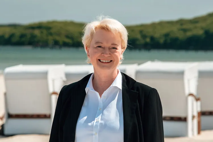 Smiling front desk manager of the Rugard Thermal Strandhotel, Birte Nagel, on the beach in Binz