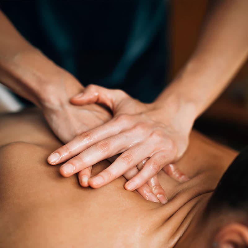 Ayurvedic pressure massage with oil in the neck area.