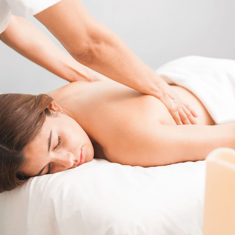 A woman during the Hawaiian relaxation treatment on her back.
