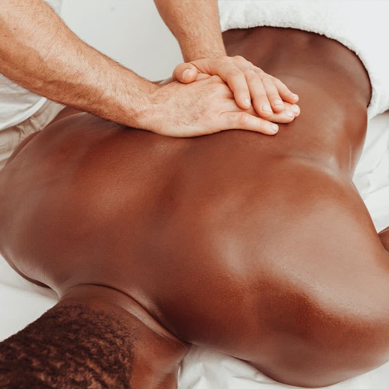 A man relaxes with a vigorous massage of the middle back muscles.