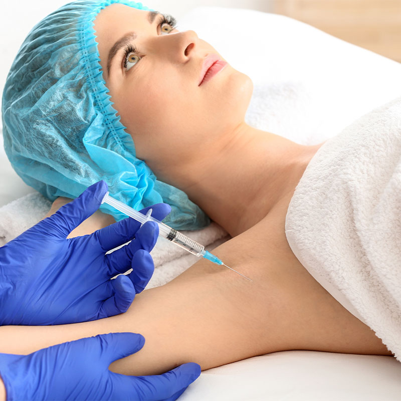 Woman receives a Botox injection to combat underarm sweat while on vacation at the Arkona Strandhotel on Rügen.